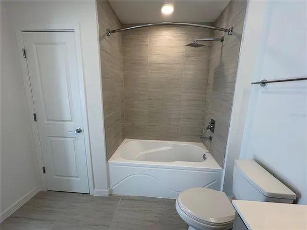 a bathroom with a toilet and a bathtub