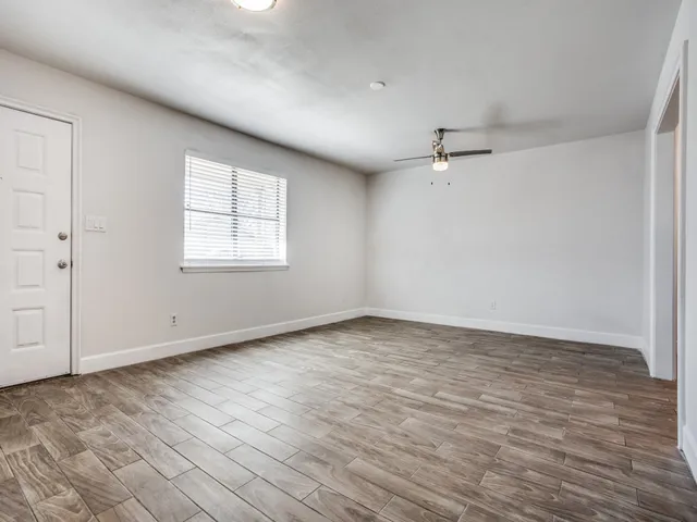 wooden floor in an empty room with a window