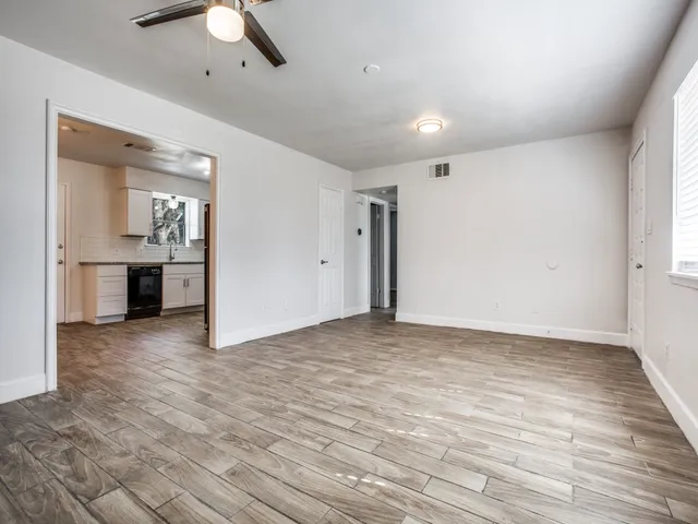 a view of a kitchen with a sink and a refrigerator