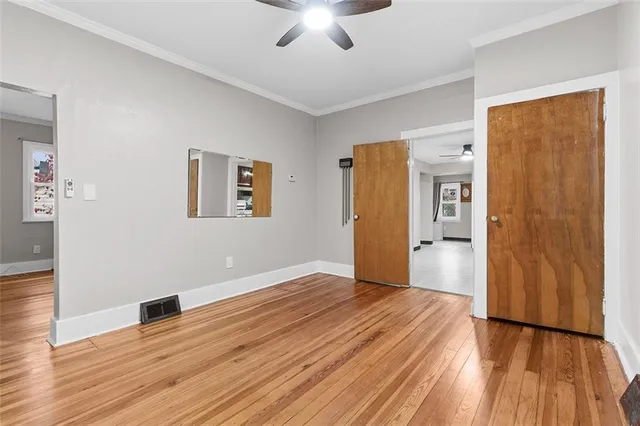 a view of empty room with wooden floor