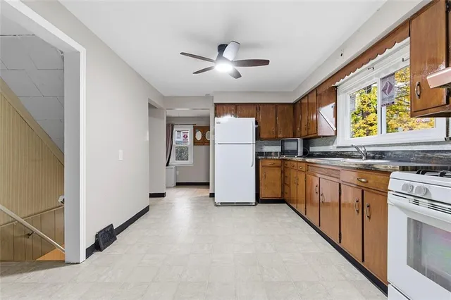 a kitchen with a refrigerator a stove top oven a sink and dishwasher