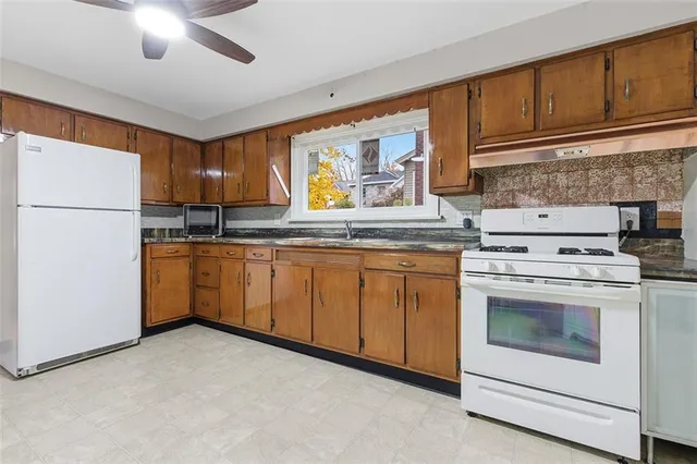 a kitchen with a stove sink and cabinets