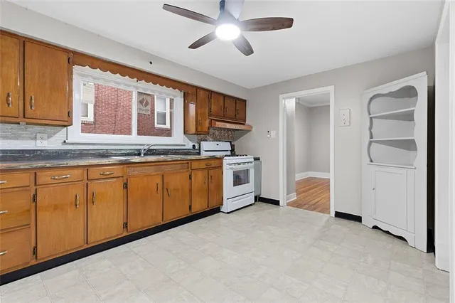 a kitchen with stainless steel appliances granite countertop a stove sink and cabinets