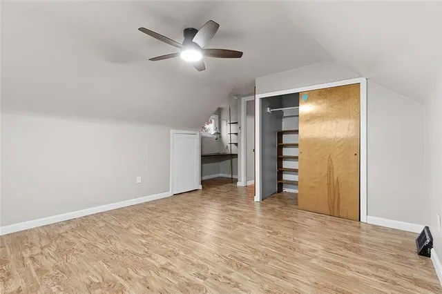 an empty room with closet and entryway