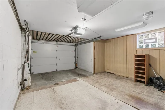 an empty room with closet and windows