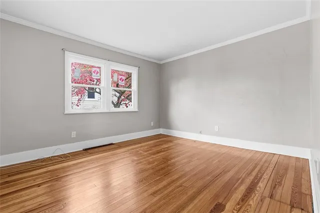 a view of room with wooden floor and window