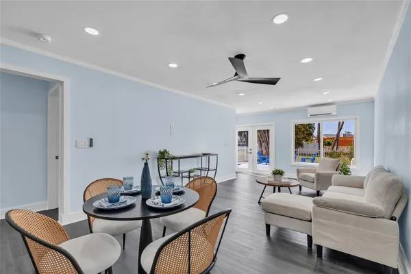 a living room with furniture and wooden floor