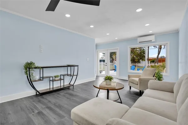a living room with furniture and wooden floor