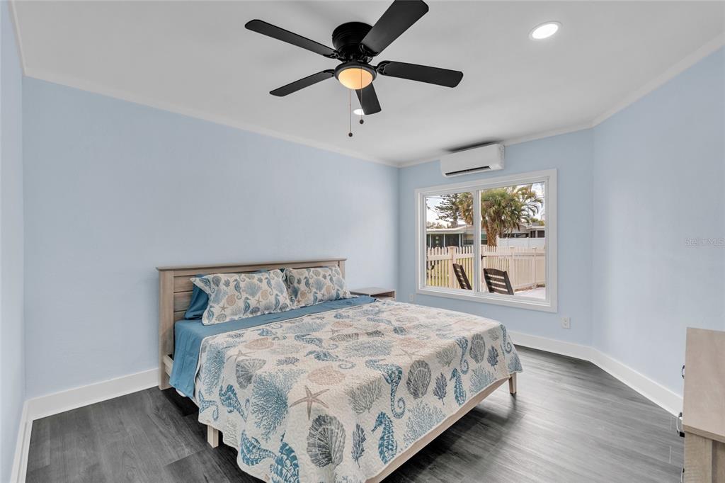 445 63rd Street Holmes Beach, FL 34217 - Photo 18 of 45 a bedroom with a bed and a window