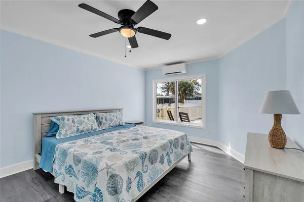 a bedroom with a large bed and a window