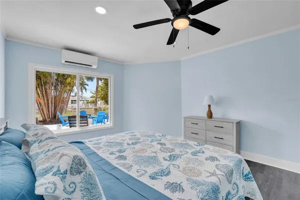a bedroom with a bed and a large window