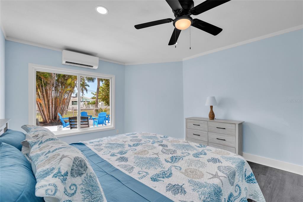 445 63rd Street Holmes Beach, FL 34217 - Photo 21 of 45 a bedroom with a bed and a large window