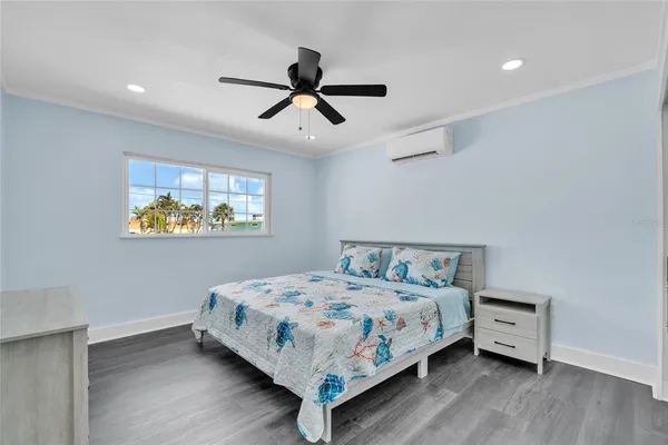 a bedroom with a bed and a ceiling fan