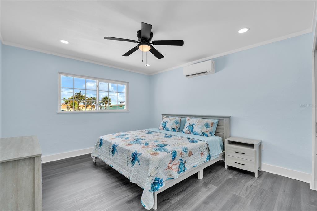 445 63rd Street Holmes Beach, FL 34217 - Photo 23 of 45 a bedroom with a bed and a ceiling fan