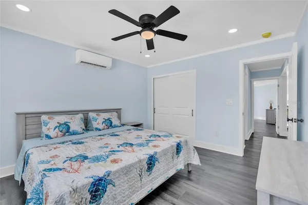 a bedroom with a bed and a chandelier