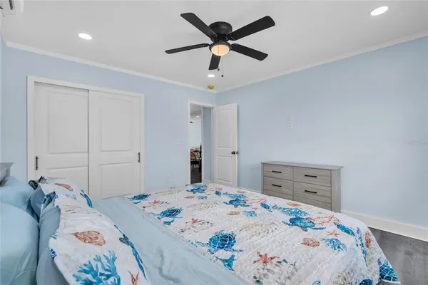 a bedroom with a bed and wooden floor