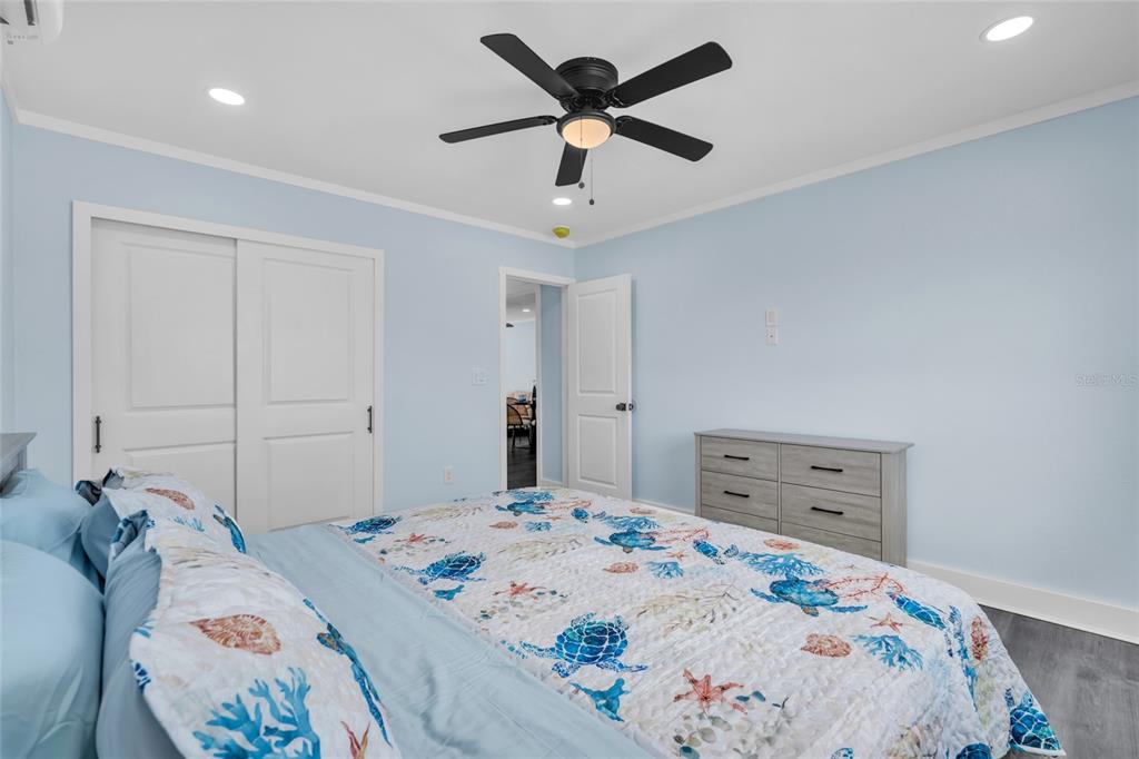 445 63rd Street Holmes Beach, FL 34217 - Photo 25 of 45 a bedroom with a bed and wooden floor