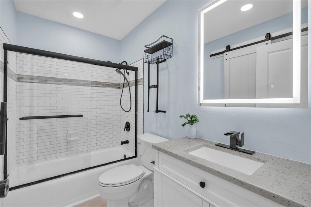 445 63rd Street Holmes Beach, FL 34217 - Photo 26 of 45 a bathroom with a granite countertop sink toilet and shower