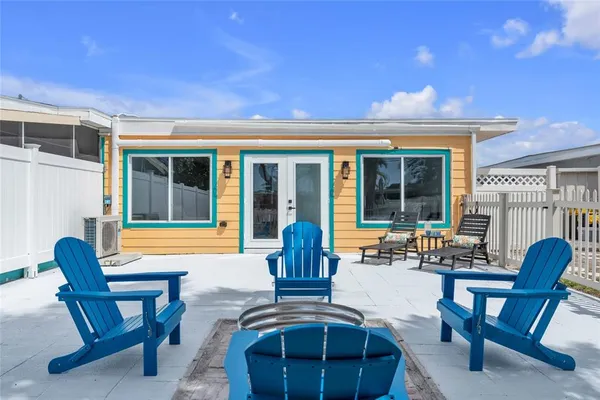 a view of a house with patio and a yard