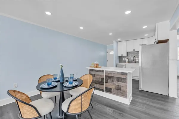 a view of a dining room with furniture wooden floor and chandelier