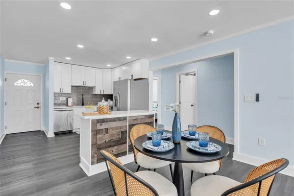 a kitchen that has a table and chairs in it