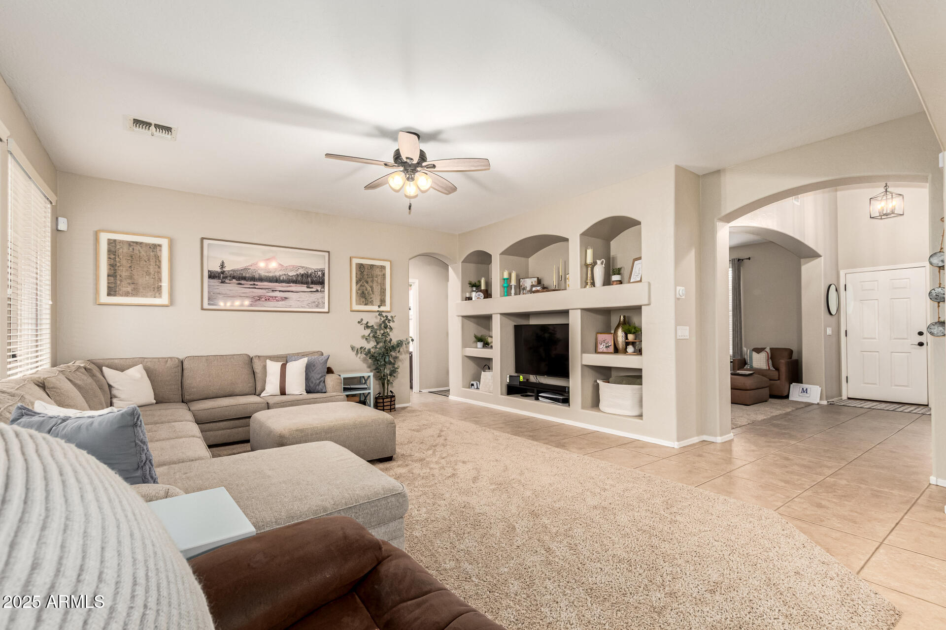 3721 South Martingale Road Gilbert, AZ 85297 - Photo 18 of 67 a living room with furniture and a fireplace
