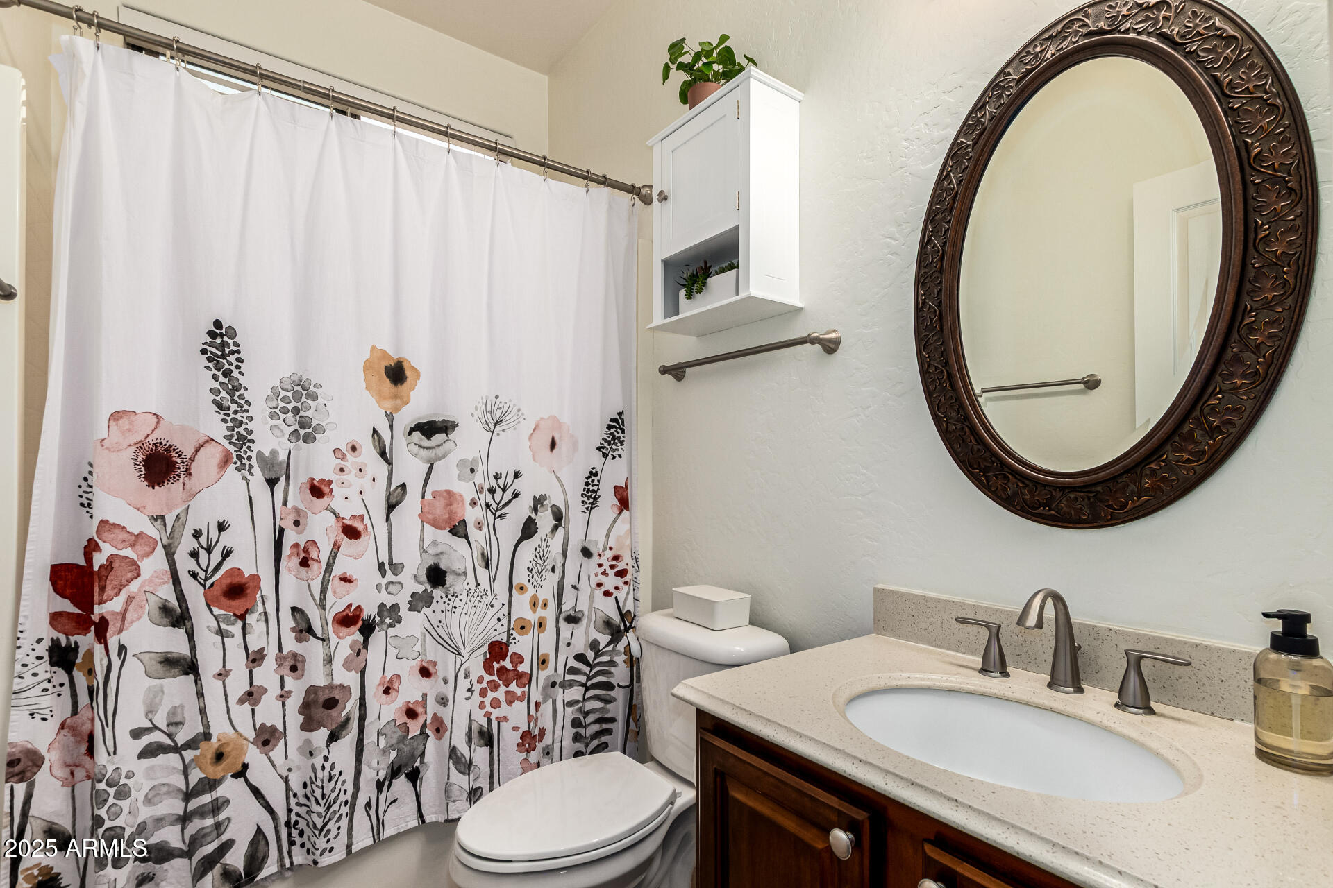 3721 South Martingale Road Gilbert, AZ 85297 - Photo 33 of 67 a bathroom with a sink a toilet and a mirror