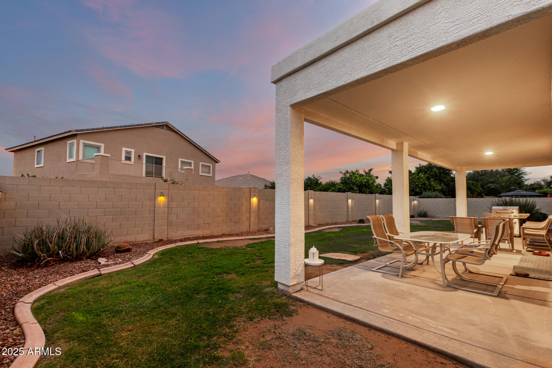 3721 South Martingale Road Gilbert, AZ 85297 - Photo 64 of 67 a view of a patio with table and chairs potted plants with floor to ceiling window