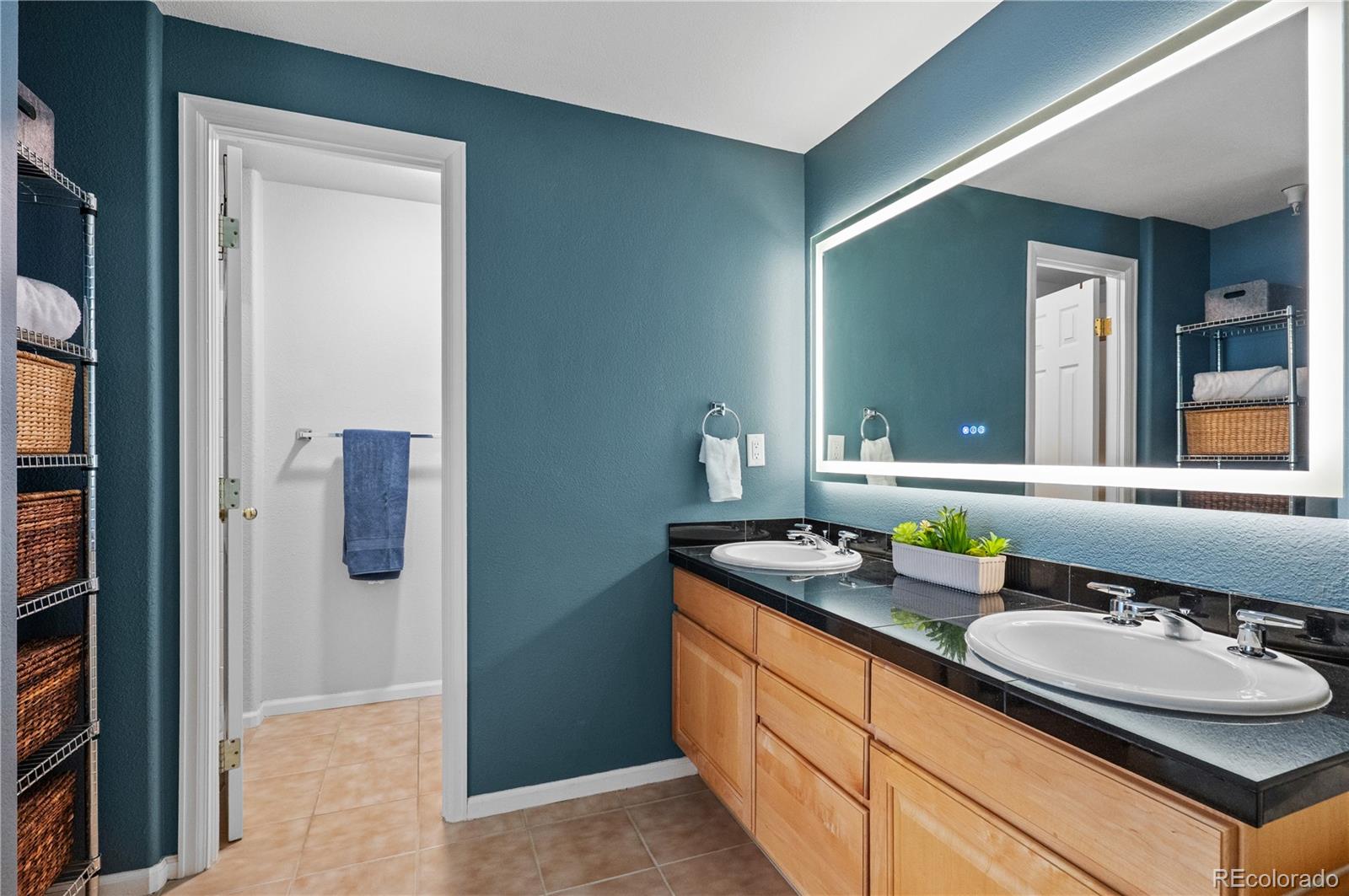 180 Cook Street, Unit 203 Denver, CO 80206 - Photo 24 of 44 a bathroom with a granite countertop sink and a mirror