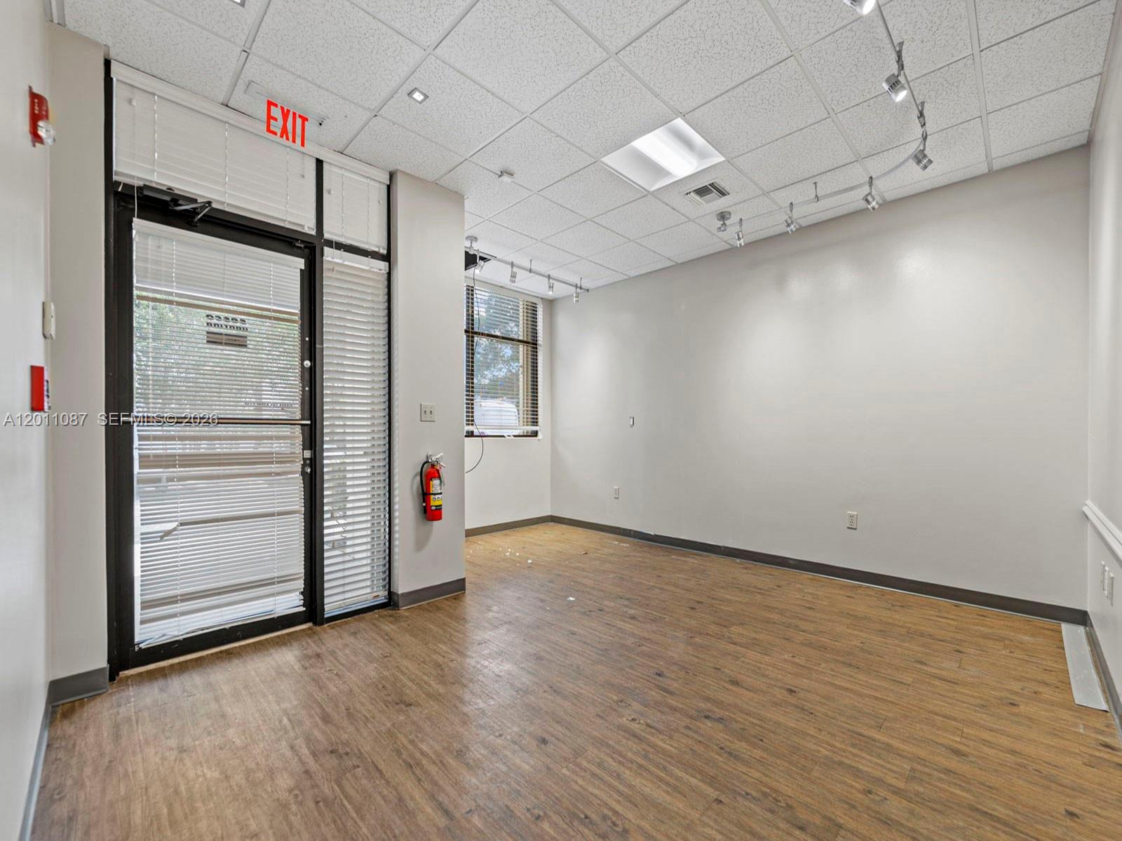 735 Shotgun Road Sunrise, FL 33326 - Photo 7 of 21 an empty room with windows