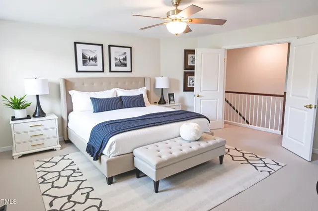 a bedroom with a bed and a table with potted plant
