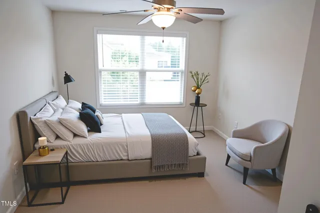 a bedroom with bed and window