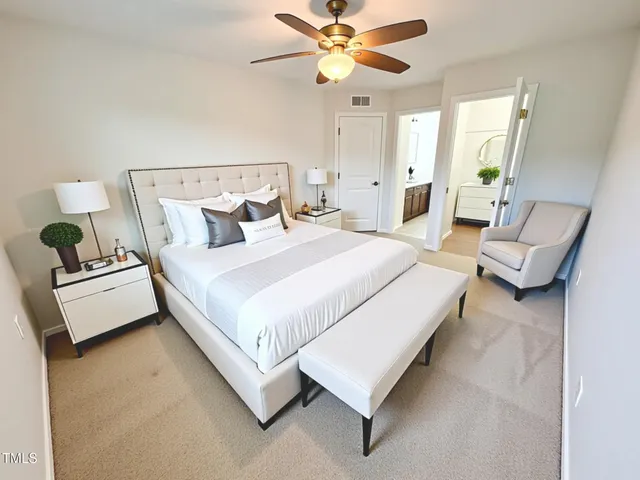 a bedroom with a bed couch and window