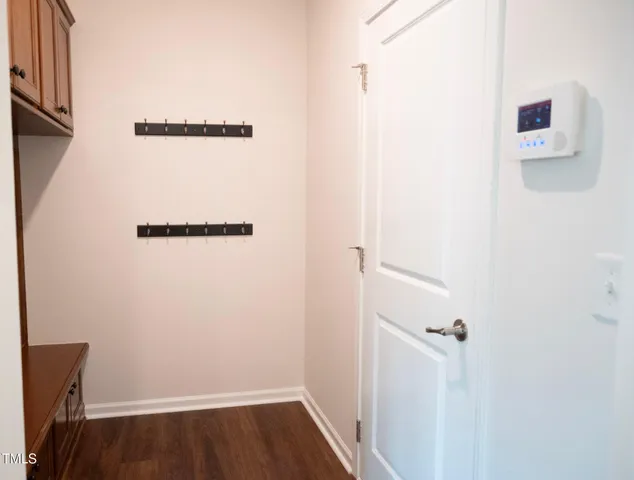 a view of a room with wooden floor