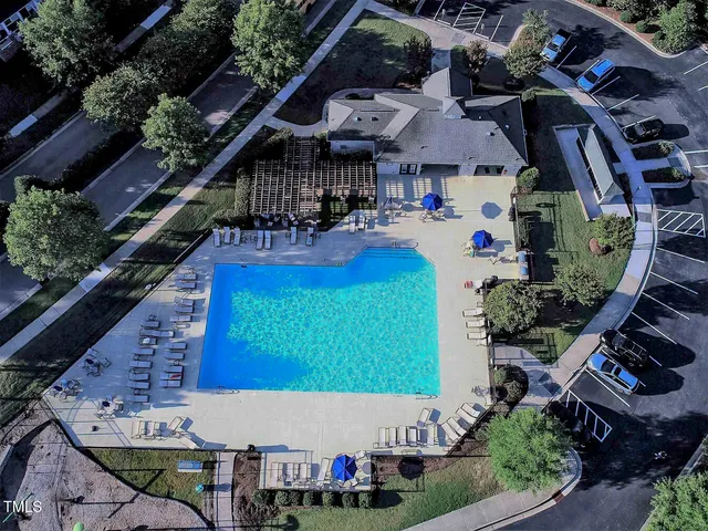 an aerial view of a house with garden space and sitting area
