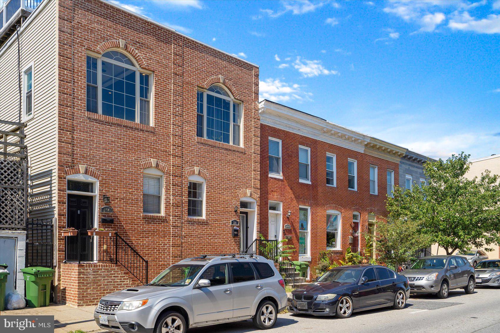 104 North Patterson Park Avenue Baltimore, MD 21231 - Photo 1 of 38 a front view of a house with cars parked