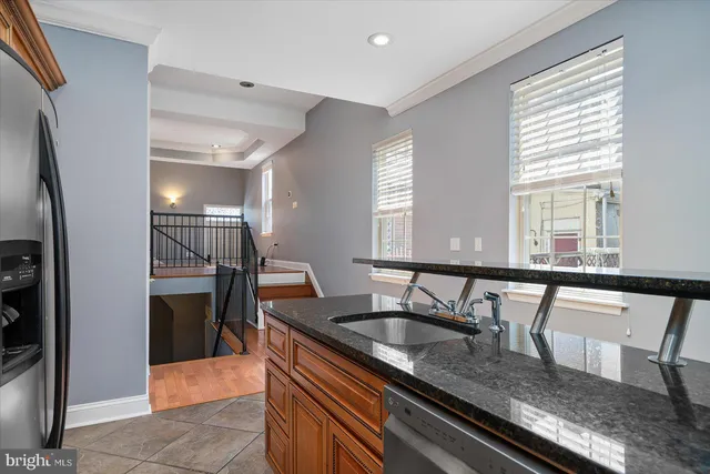 a kitchen with granite countertop a sink and a stove top oven