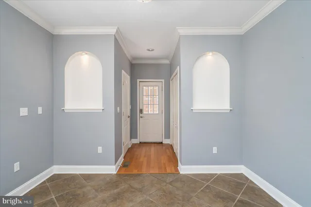 an empty room with windows and closet