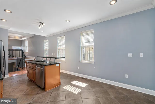 a kitchen with stainless steel appliances granite countertop a stove and a sink