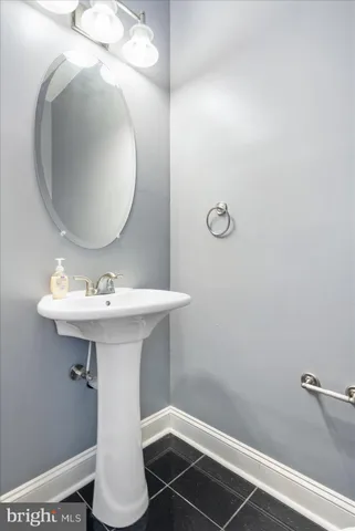a bathroom with a sink toilet and mirror