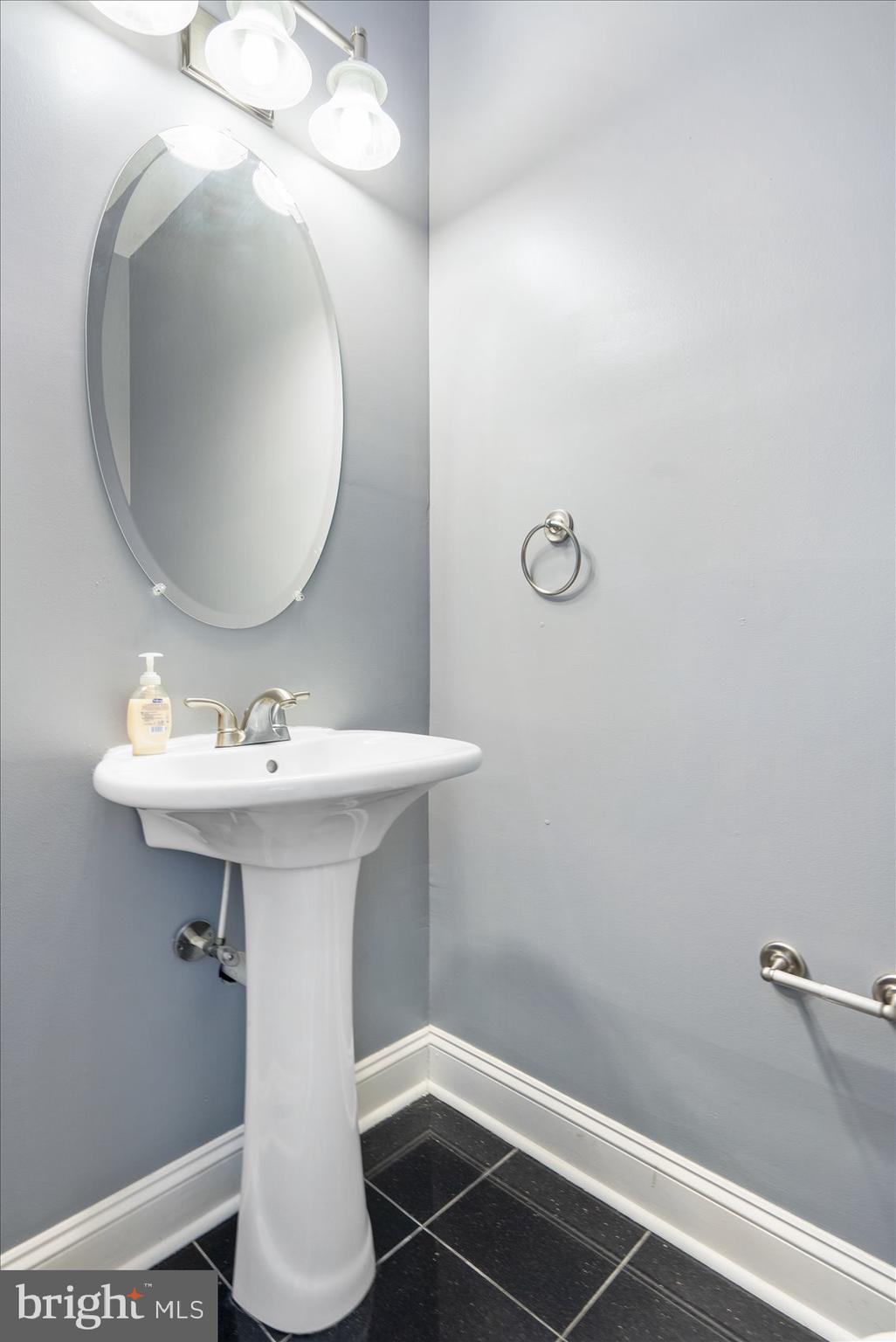 104 North Patterson Park Avenue Baltimore, MD 21231 - Photo 18 of 38 a bathroom with a sink toilet and mirror
