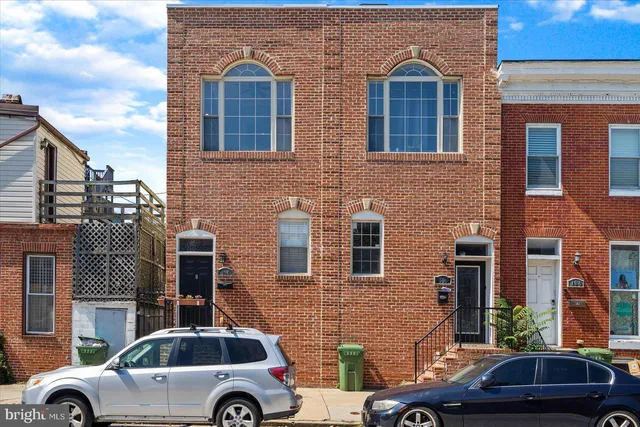 a front view of a house with parking space