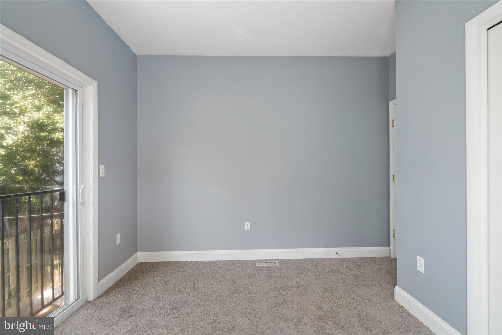 104 North Patterson Park Avenue Baltimore, MD 21231 - Photo 25 of 38 an empty room with wooden floor and windows
