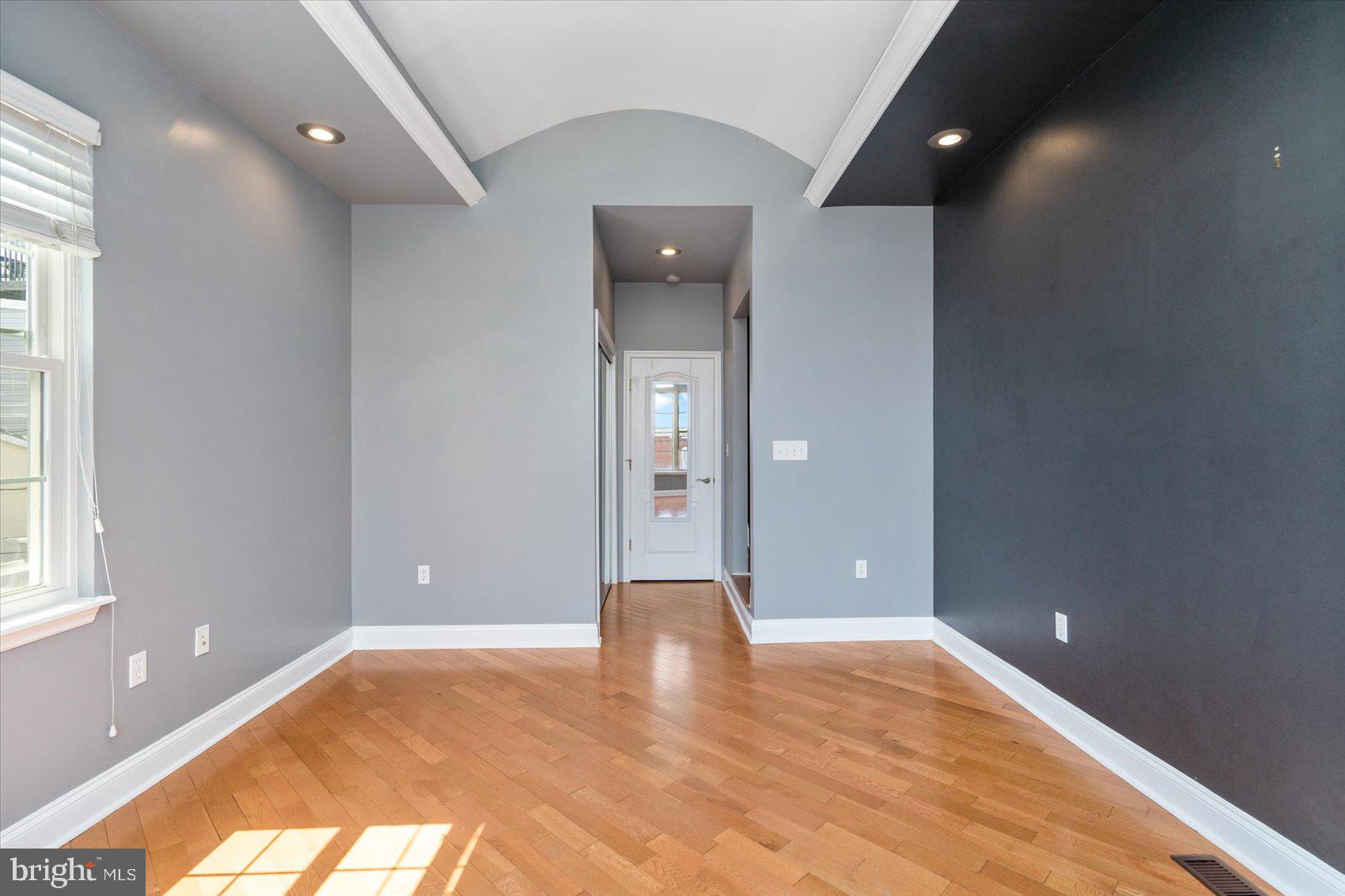 104 North Patterson Park Avenue Baltimore, MD 21231 - Photo 31 of 38 a view of an empty room with wooden floor and a window