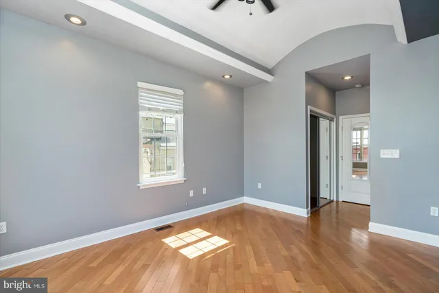 a view of a livingroom with wooden floor and a window