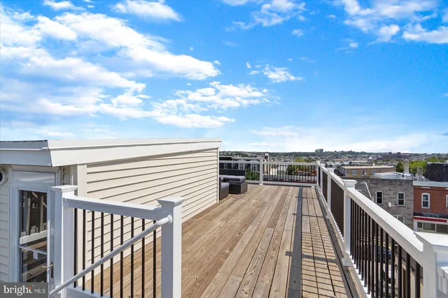 a view of a balcony with wooden floor