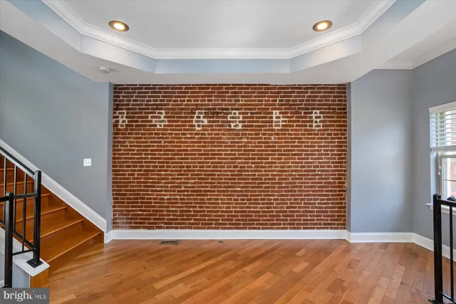 a view of an empty room with wooden floor