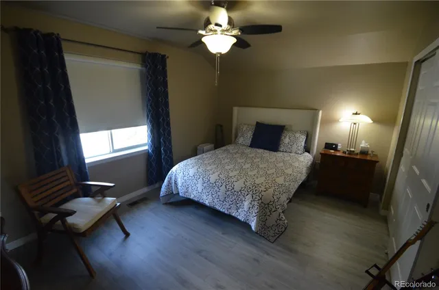 a bedroom with a bed lamp and a chandelier