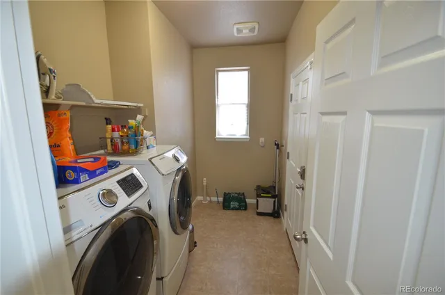 a living room with furniture a couch and a chandelier