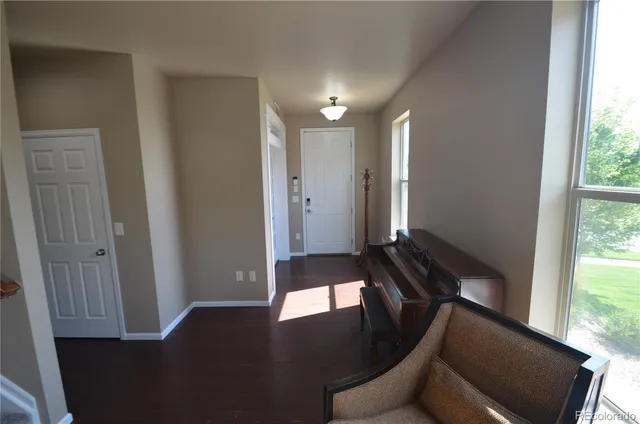 a view of hallway with furniture and a front door
